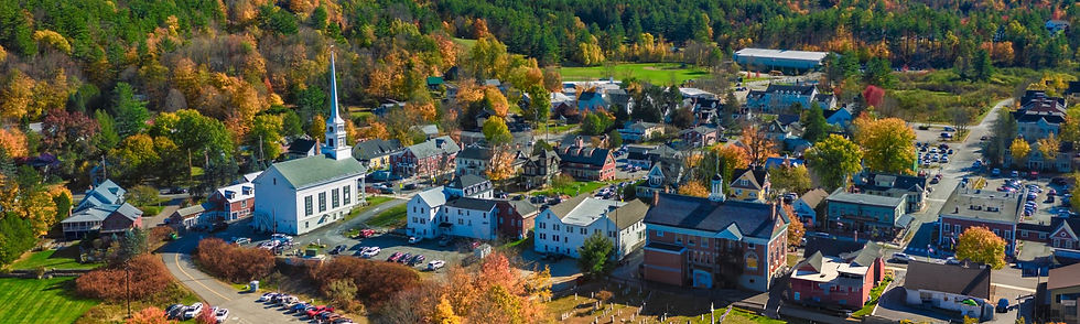Londonderry, NH aerial view of the town with church and city official buildings surrounded by trees in early fall