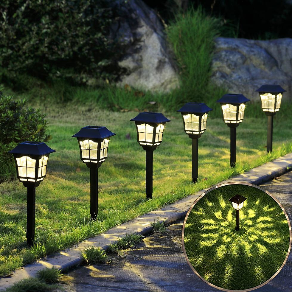 Row of glowing solar garden lights along a grassy path at night, emitting a warm glow. Insert shows radial light pattern on grass.
