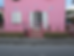 A vibrant pink house with white shutters and a decorative pink fence, embodying a whimsical and playful Barbie aesthetic. The house features floral and butterfly wall decor, perfect for those looking for Barbie wall decor inspiration.