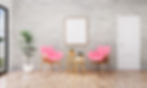 Two pink-cushioned chairs face each other in a modern, bright room with wooden floors. A small table holds plants and a white mug. Minimalist vibe.