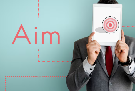 Man in suit holds tablet with target image over face on a teal background. Red text reads "Aim," with dotted lines and focused mood.