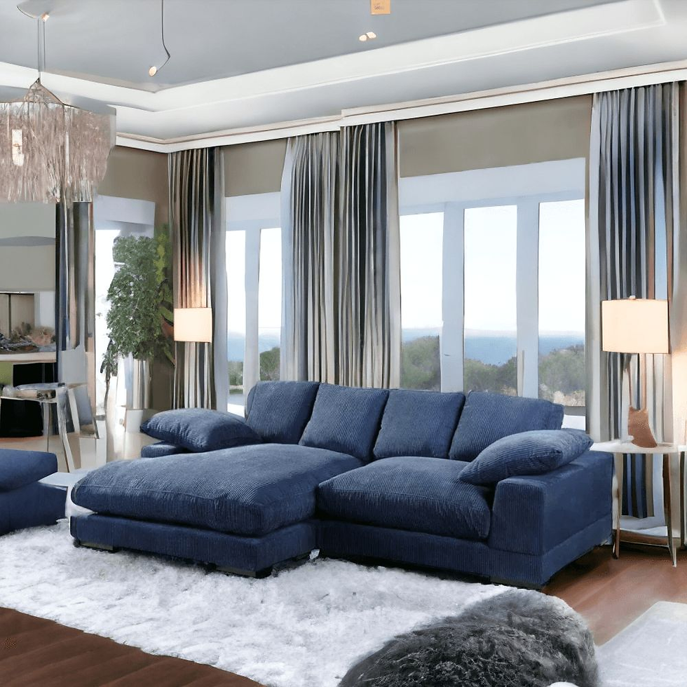 A cozy living room with a blue sectional sofa, large windows, and white curtains. Two lamps and a fluffy white rug add warmth.