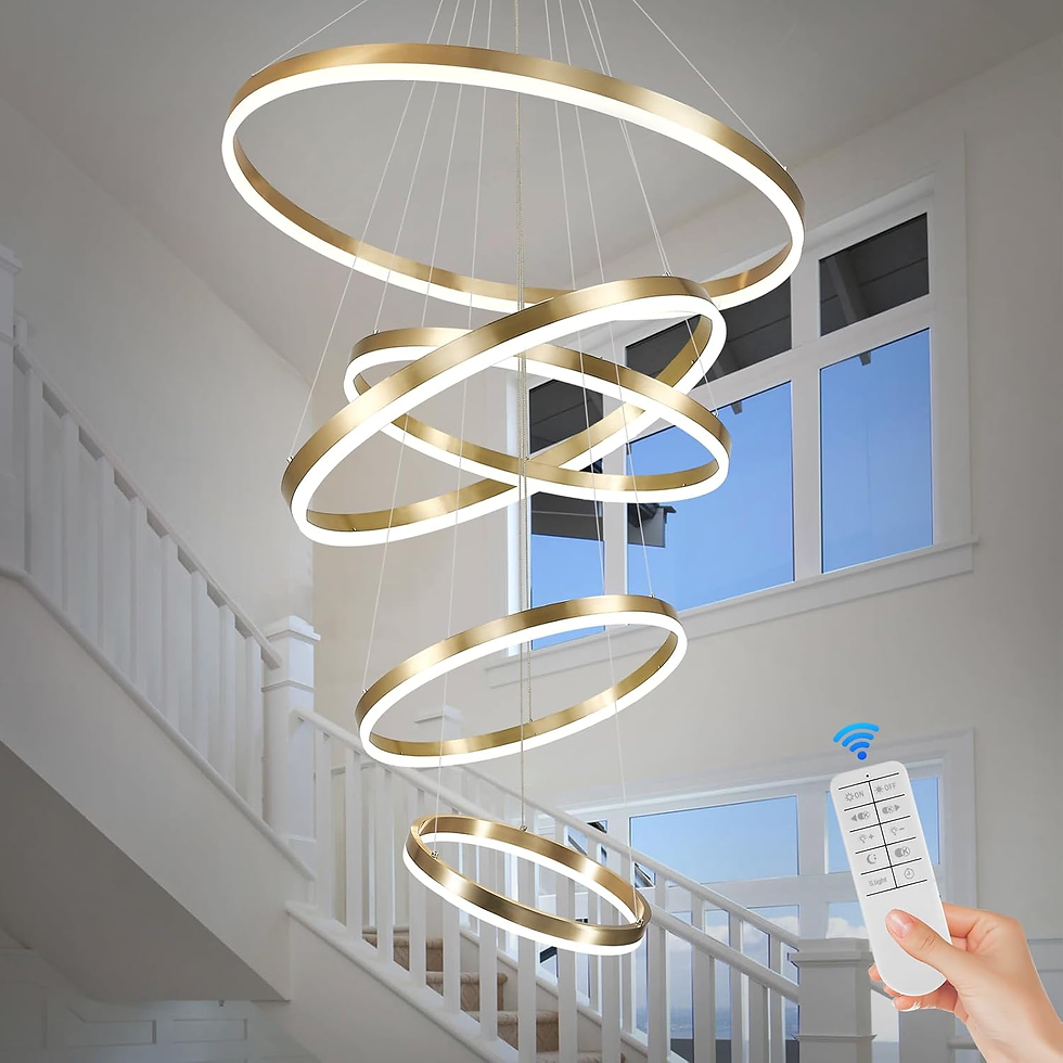 Modern chandelier with gold rings hangs in a bright stairway. A hand holds a remote, hinting at adjustable lighting. Blue sky visible.