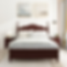 Cozy bedroom with a dark wood bed, white bedding, and bedside tables. Two landscape paintings above. Soft light creates a calm atmosphere.