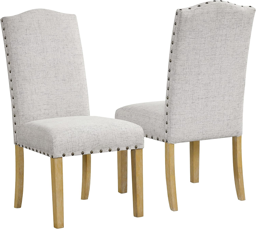 Two beige upholstered chairs with nailhead trim and wooden legs, set against a plain white background, facing each other at an angle.