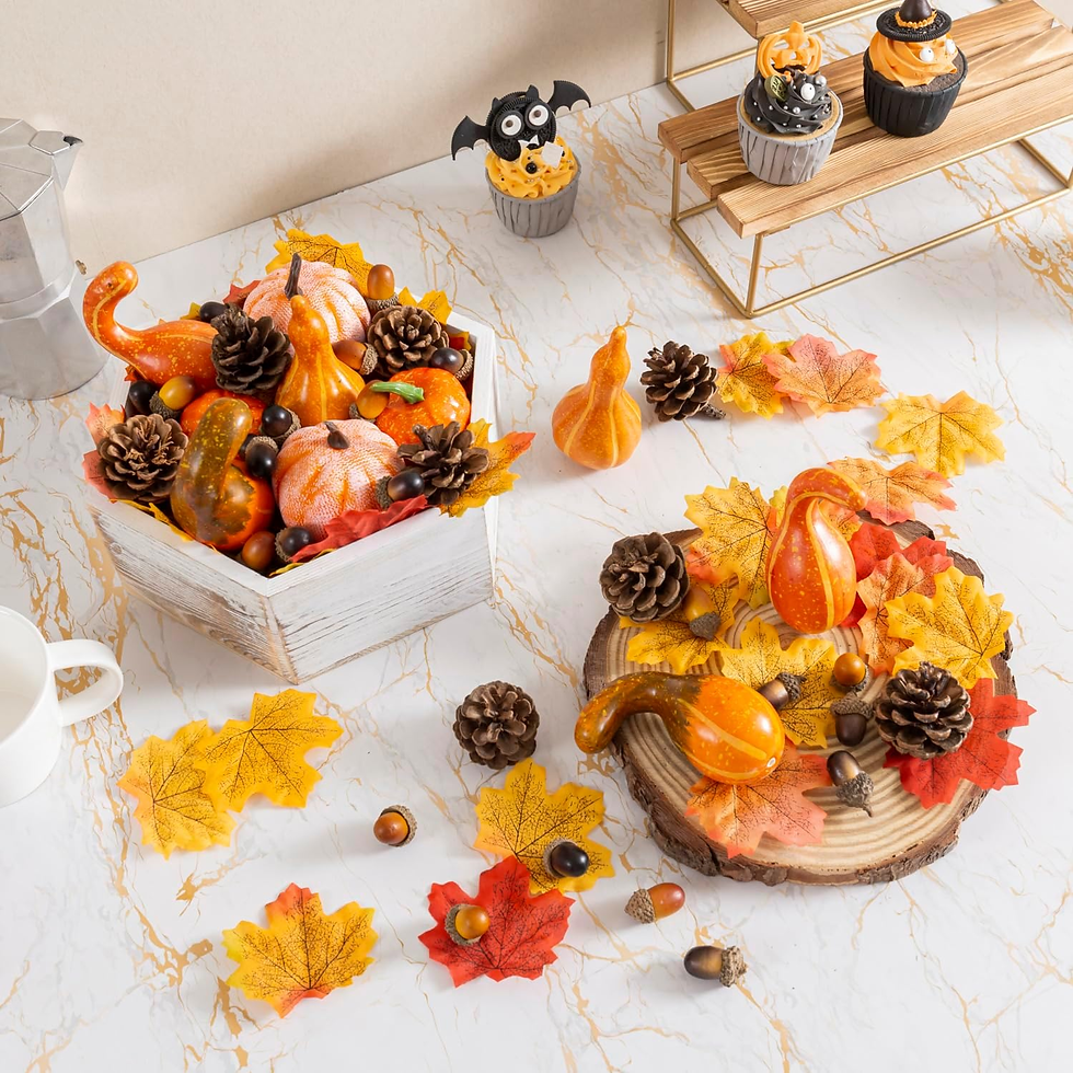 A fall table centerpiece made with pumpkins, gourds, apples, and greenery.