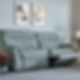 Gray reclining sofa in a cozy living room, plaid blanket draped on the side. Two abstract paintings on the wall. Soft, relaxed vibe.