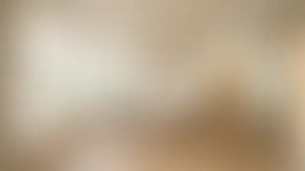 Bright living room with a gray sofa, beige cushions, wooden coffee table, large mirror, and bookshelf. Sunlight streams through big windows. Cozy vibe.