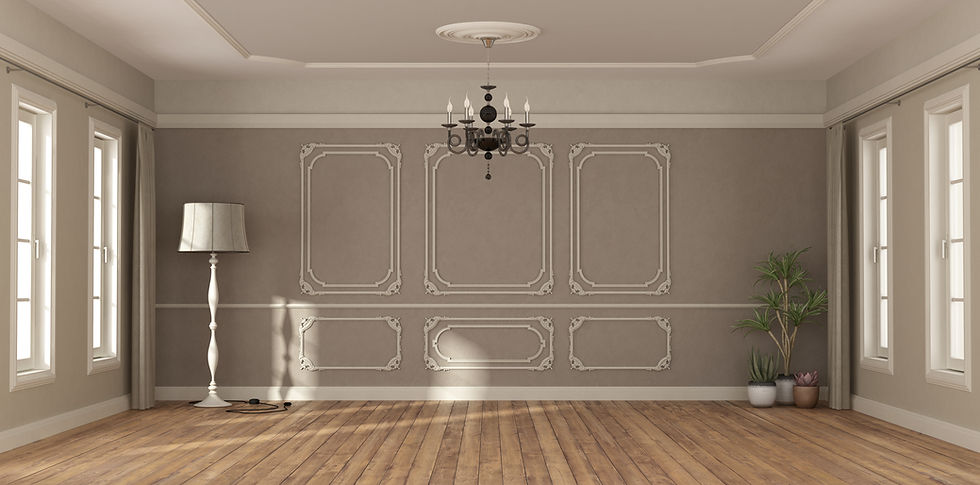 Elegant empty room with ornate walls, wooden floor, and a chandelier. A white floor lamp and potted plants are against a taupe wall.