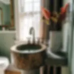 Rustic bathroom with a wooden sink, vintage faucet, and tall vase of dried flowers. Sunlight filters through a window curtain, casting a warm glow.