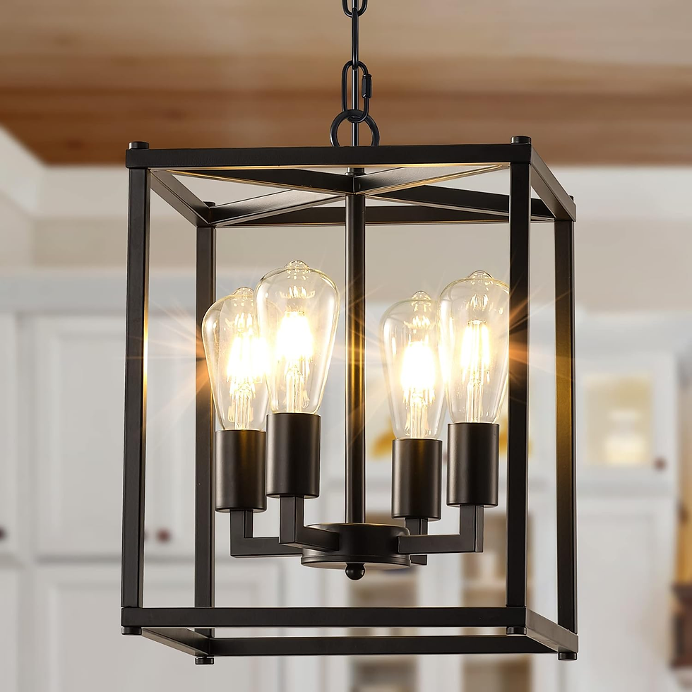 Black metal chandelier with four glowing bulbs inside a kitchen setting. Warm light casts a cozy ambiance. White cabinets in the background.