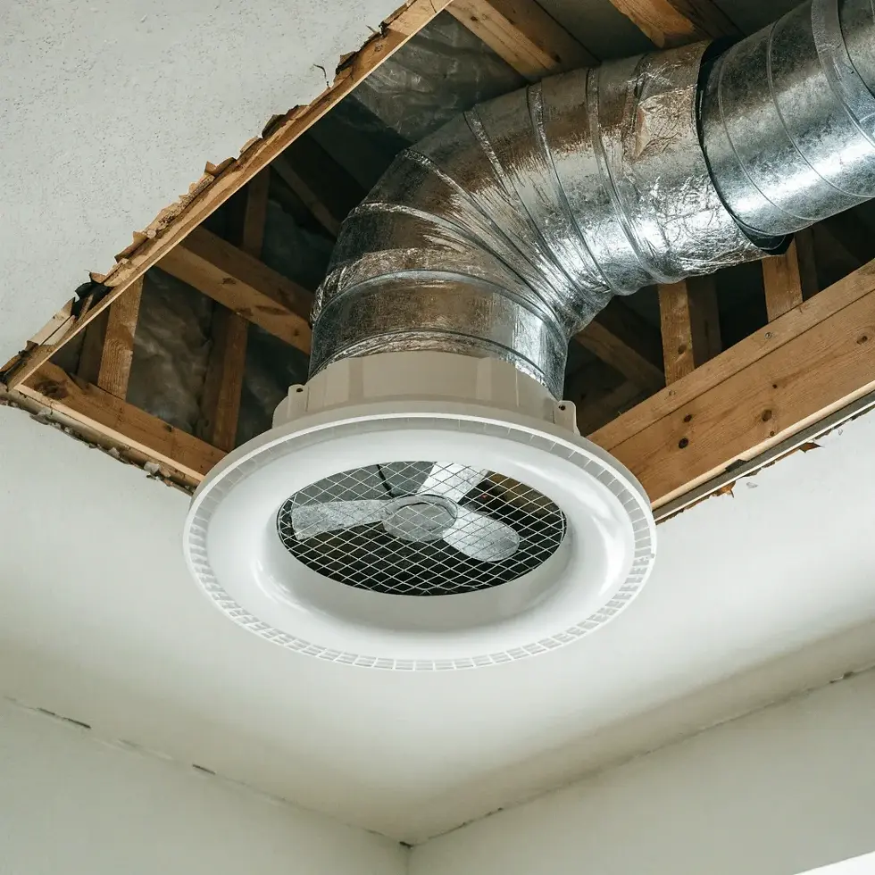 Ceiling vent with silver ductwork exposed through a ceiling opening, surrounded by wooden beams. Neutral tones, industrial setting.