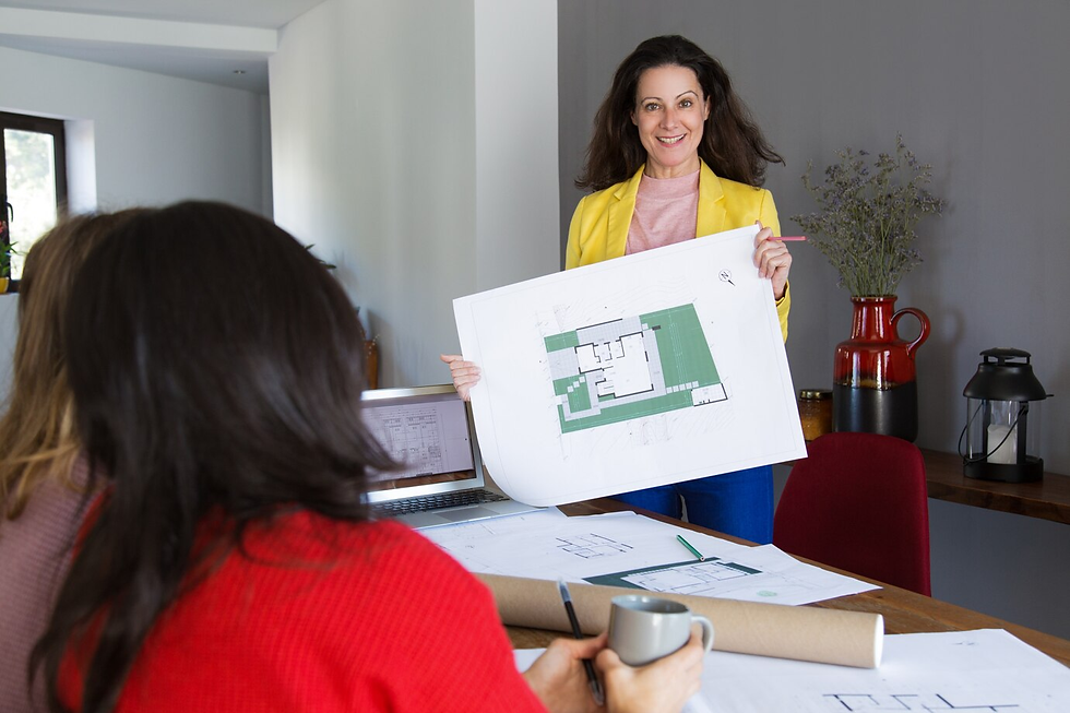 "Interior designer presenting a detailed floor plan to clients during a consultation in Port Stephens."