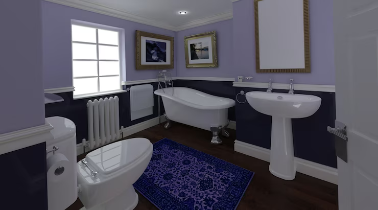 Elegant bathroom with lavender walls, white fixtures, a freestanding tub, and navy rug. Two framed photos and a window enhance the serene mood.