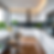Modern kitchen with white cabinets, stainless steel appliances, wooden floor, and plants. A bowl of lemons sits on the island. Bright, airy mood.