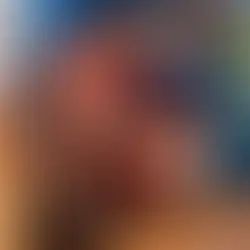 A cozy orange armchair with a draped knit blanket sits on a wooden floor. Shelf with quirky animal vases in a colorful room.