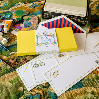 Yellow A Post In Time stationery set with envelopes and various art supplies nearby.