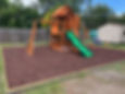 Outdoor furniture assembly of a playset on mulch.