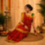 Woman wearing a traditional red and gold Ara chunari