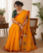 Woman in a yellow and red cotton malmal saree.
