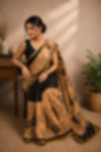 Woman in a black and beige printed cotton malmal saree.