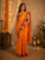 Woman wearing a red Chunari cotton malmal saree.