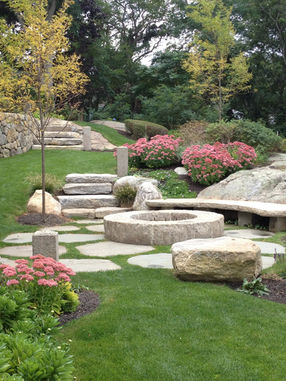 natural stone patio with fire pit, granite steps, and landscape design in Massachusetts