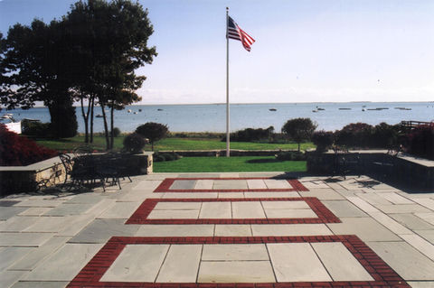 bluestone patio with brick inlay and waterfront landscape design in Scituate Massachusetts