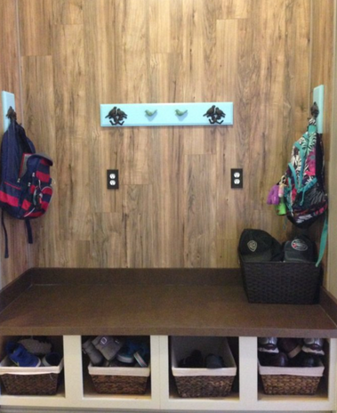 Mudroom area with wood paneling and laminate countertop. 