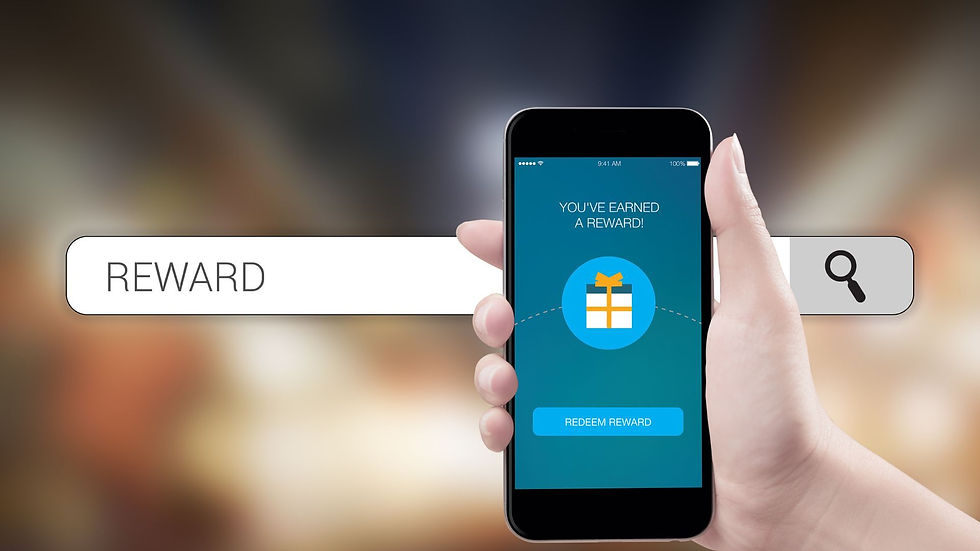 hand holding a mobile that reads you have earned rewards