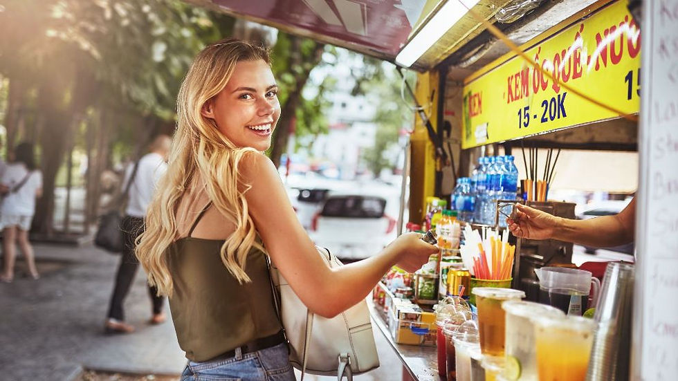 A smiling woman buying from small business kiosks