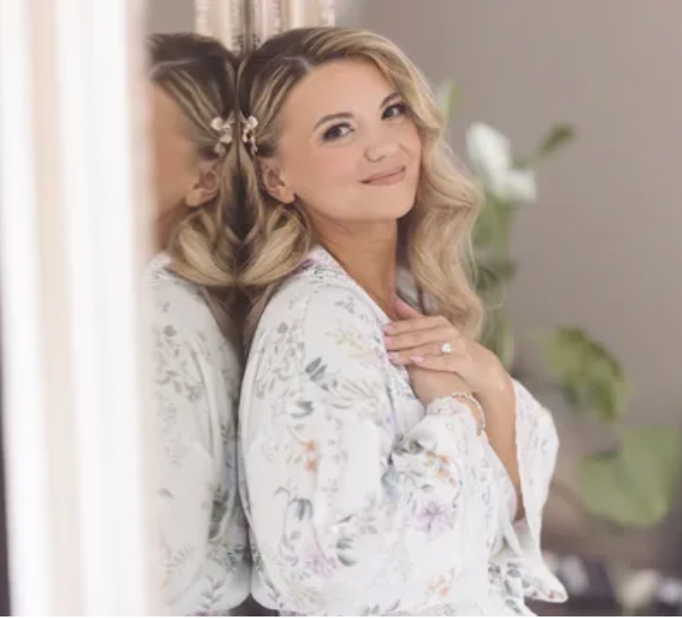 A magical first look moment at Brookshire in Delaware, Ohio. Kristi stuns in a gown from Dublin Bridal, with flawless hair and makeup by Goode Beauty. Photography by Feel Story Creative.