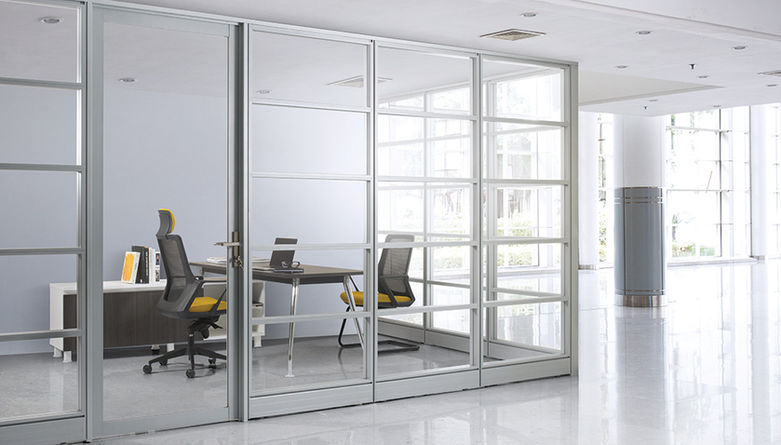 Modern office interior with glass partitions and ergonomic chairs