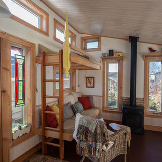 built custom tiny house, backyard suite, alternative, creative interior design, fireplace, day bed, earthen floor, thermal mass, medicine hat clay, beeswax finish, cochrane, ab.