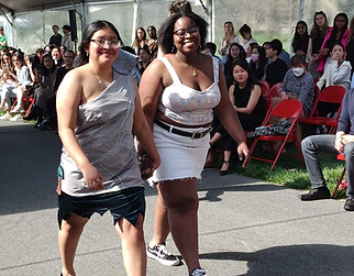women walking hand in hand