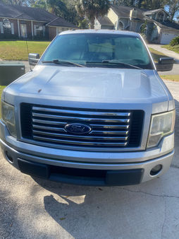 Before Wash & Wax – Ford F-150 covered in dirt and grime, with dull paint and a cloudy windshield, needing professional auto detailing to restore its shine.