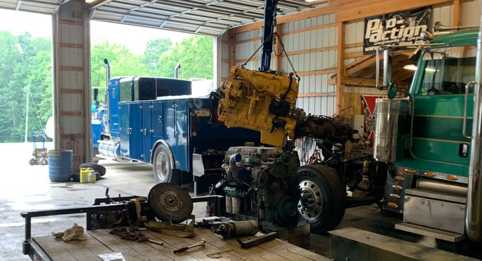 Ryan and "Big Blue" working on a repair at the garage