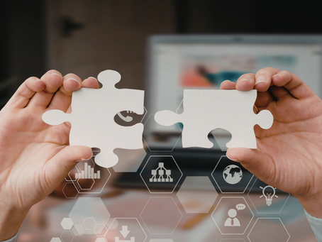 Hands connecting two puzzle pieces with digital technology icons, representing integrated CRM and ATS features for executive search