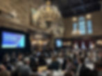 A full audience at The Harvard Club in New York City attends Hunt Scanlon’s AI-focused conference, with “Reshaping the Talent Playbook in the Age of AI” displayed on screen.