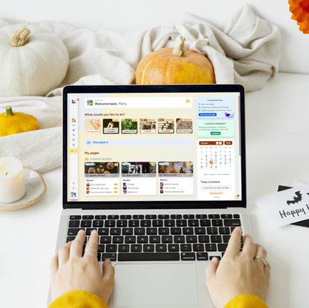 a cozy autumn setup with a candle and pumpkin on soft linens to the left, and a laptop on the right displaying Hylark's digital workspace.