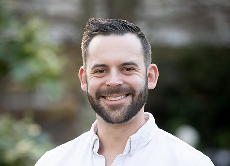 Phil Quinn-Rogers, Customer Success Manager, wearing a white shirt and smiling.