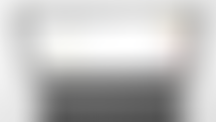 Workspace setup with a laptop displaying the Hylark “Permissions and access” dashboard. A coffee cup with latte art, a coiled black cable, and a notepad surround the laptop.