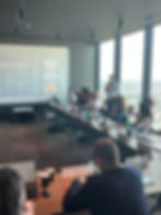 Max Woolger of Ezekia presents to EMA Partners attendees in a Tokyo high-rise meeting room, with city skyline views and a slide on “The Potential Future.”
