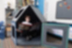 Superspace creates inviting reading retreats that draw kids into books - a cozy house-shaped nook becomes a child's favorite spot for quiet literacy time.