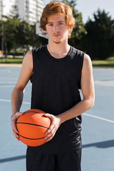 medium-shot-boy-with-basketball-ball.jpg