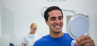 patient-checking-his-teeth-mirror.jpg