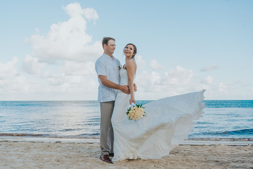 Bride and groom sharing a quiet moment with a scenic Cancun resort view behind them
