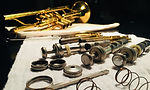 Brass trumpet pieces lay out during instrument cleaning and repair.jpg