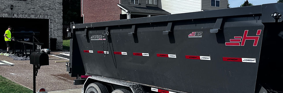 A 16-yard roll-off dumpster parked in a residential driveway for a bathroom remodel project in Mt. Juliet, TN.