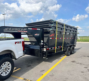 Five Brothers Dumpsters truck and trailer setup delivering a driveway-friendly 16-yard roll-off dumpster rental in Lebanon, Tennessee.